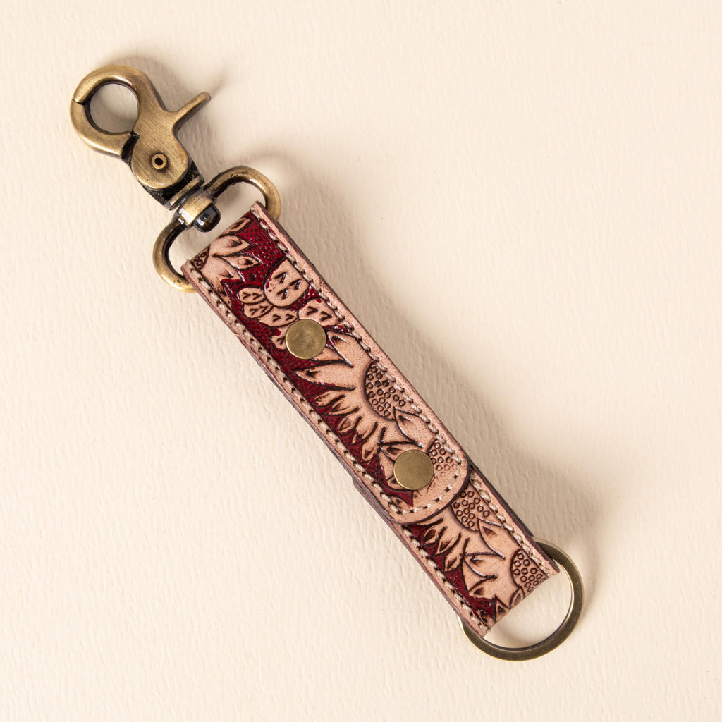 Hand-tooled leather floral keychains with feather, vine and sunflower designs, photo 6