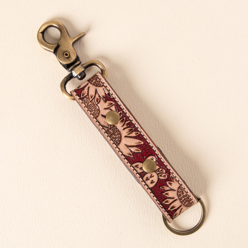 Hand-tooled leather floral keychains with feather, vine and sunflower designs, photo 5