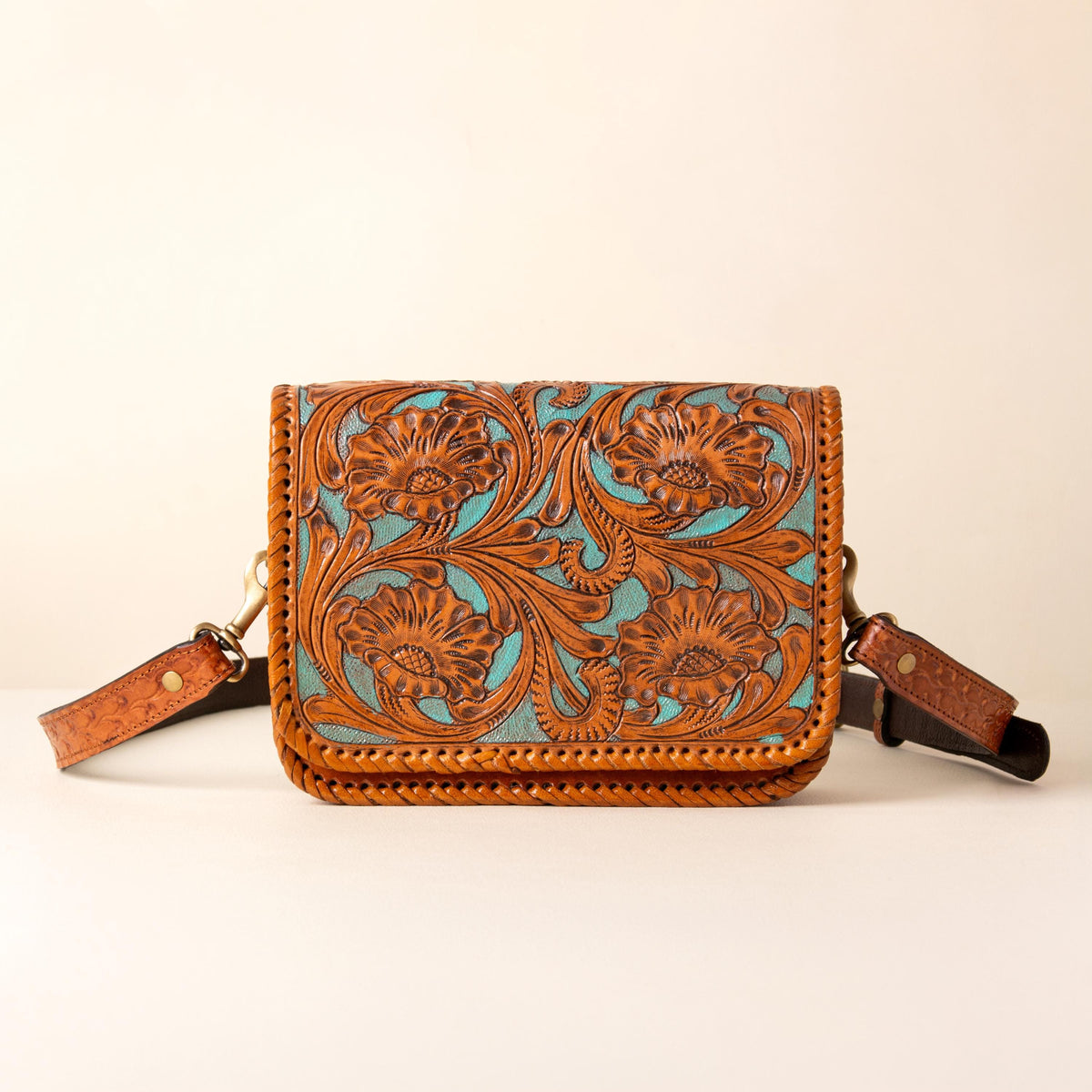 Hand-tooled leather crossbody bag with four floral medallions and braided edge, photo 1