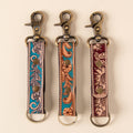 Hand-tooled leather floral keychains with feather, vine and sunflower designs, photo 1