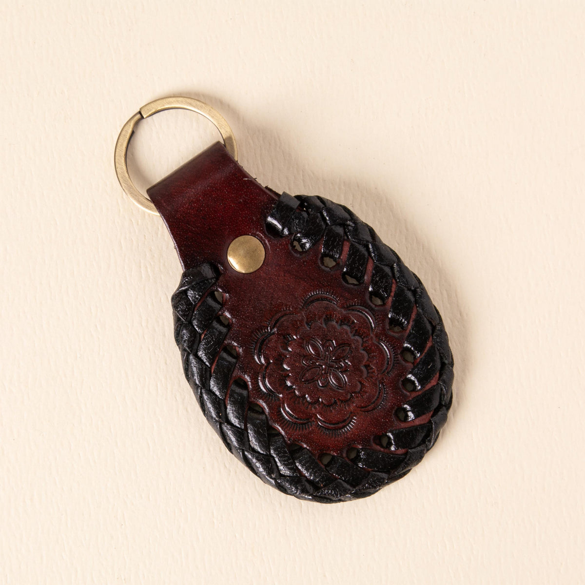Hand-tooled leather teardrop keychains in forest green, cognac and oxblood with floral medallions and braided edges, photo 3