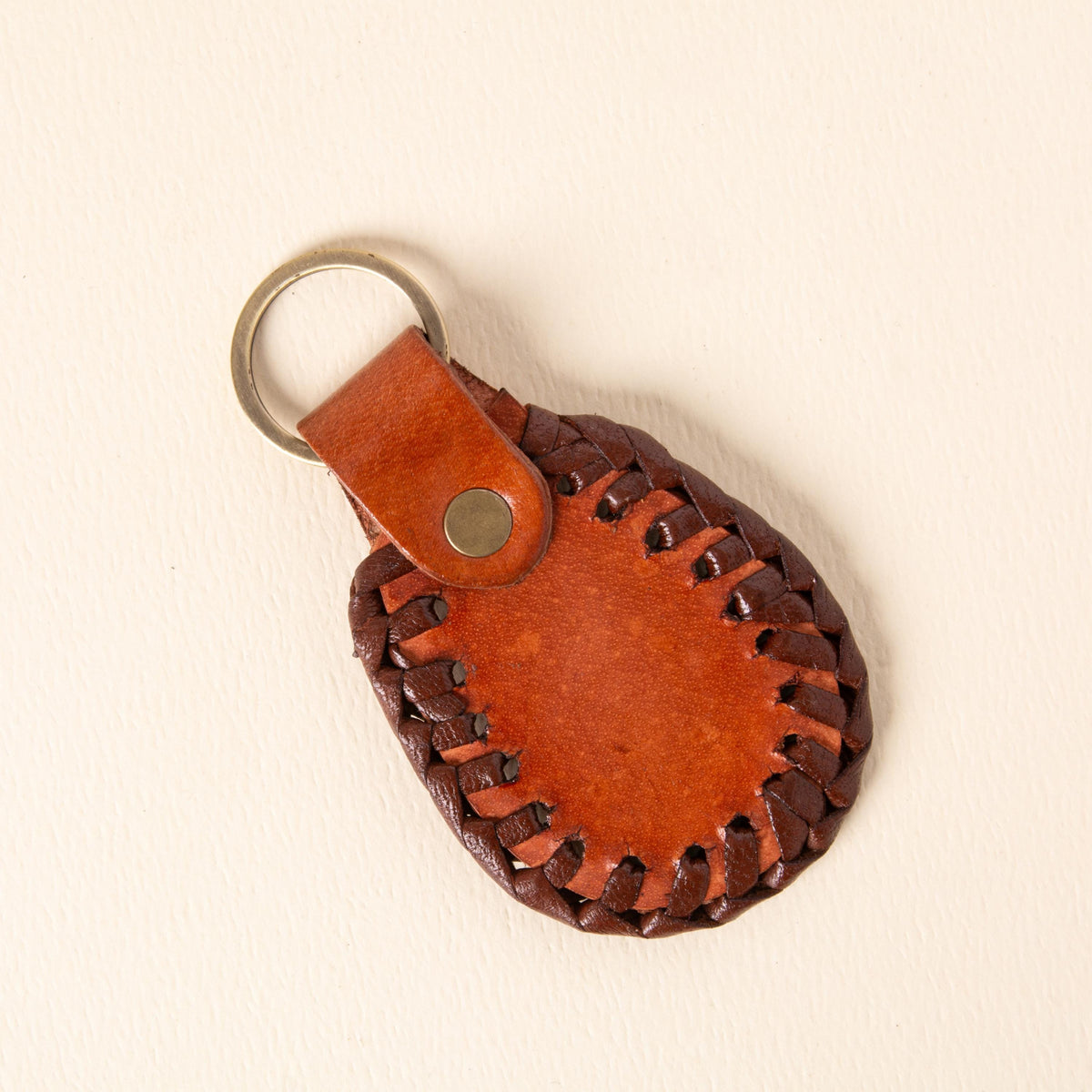 Hand-tooled leather teardrop keychains in forest green, cognac and oxblood with floral medallions and braided edges, photo 6