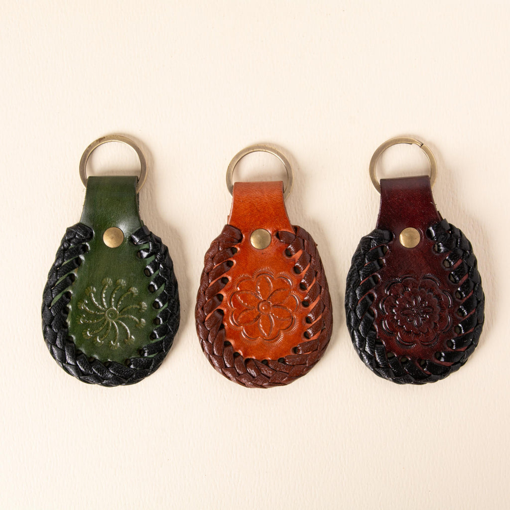 Hand-tooled leather teardrop keychains in forest green, cognac and oxblood with floral medallions and braided edges, photo 1