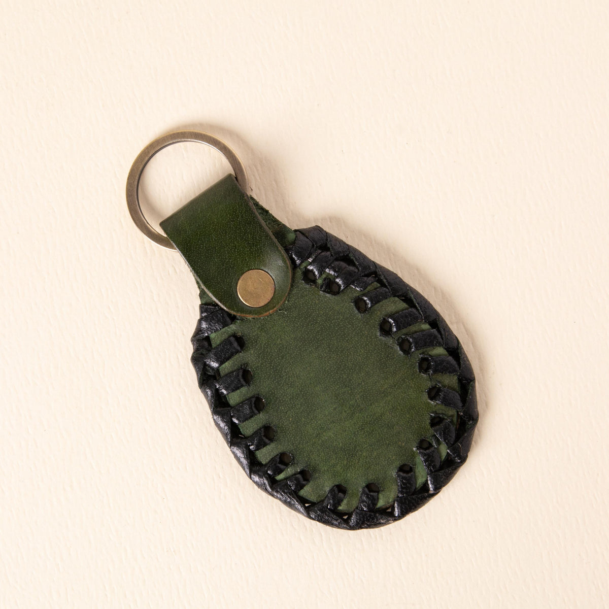 Hand-tooled leather teardrop keychains in forest green, cognac and oxblood with floral medallions and braided edges, photo 8