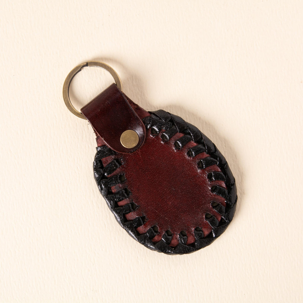 Hand-tooled leather teardrop keychains in forest green, cognac and oxblood with floral medallions and braided edges, photo 4